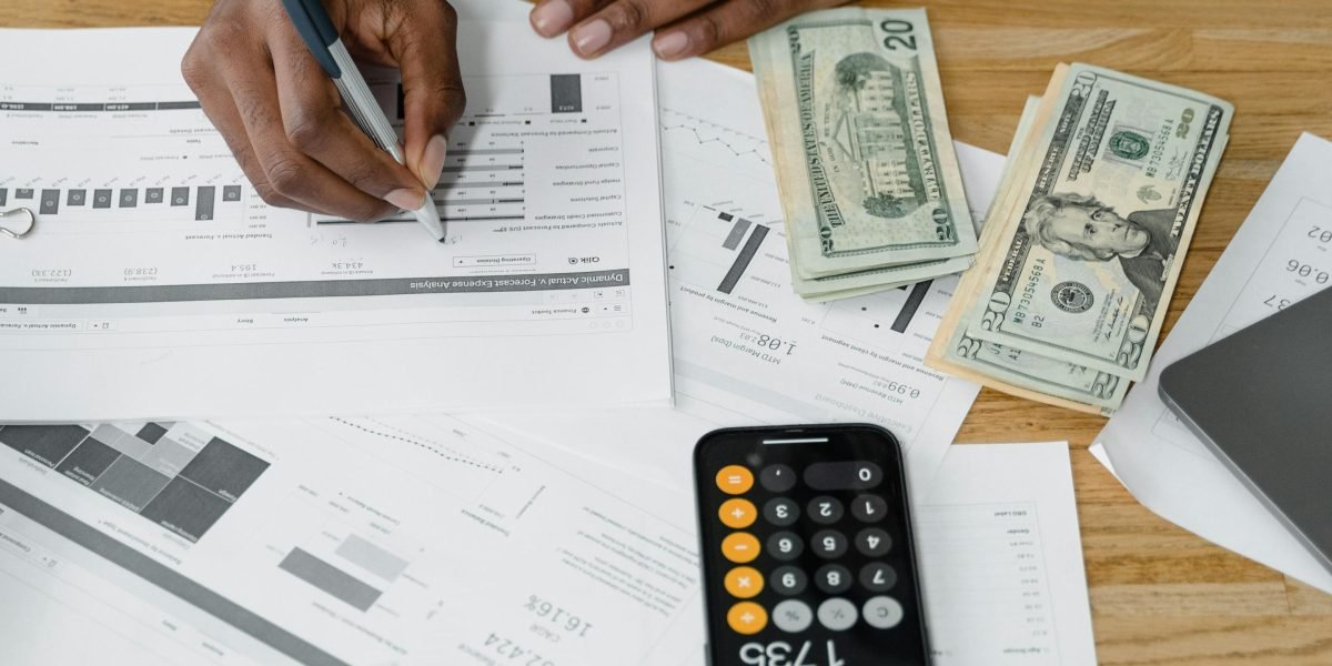 An individual thoughtfully reviewing documents, symbolizing the strategic planning required for financial investments.