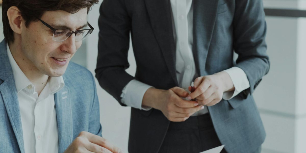 Two business partners engaged in a discussion, illustrating the collaboration and strategic decisions involved in business setup.
