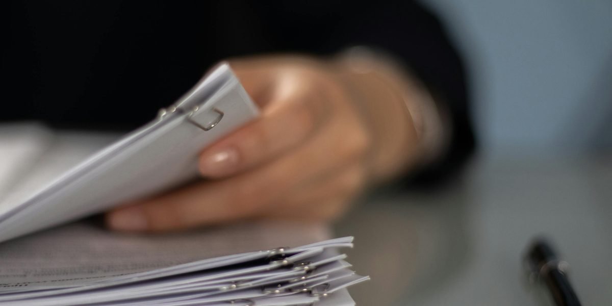 A professional meticulously reviewing documents for due diligence in an financial investment.