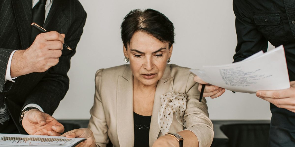 Professionals conducting thorough due diligence, carefully examining documents and financial reports before investment.