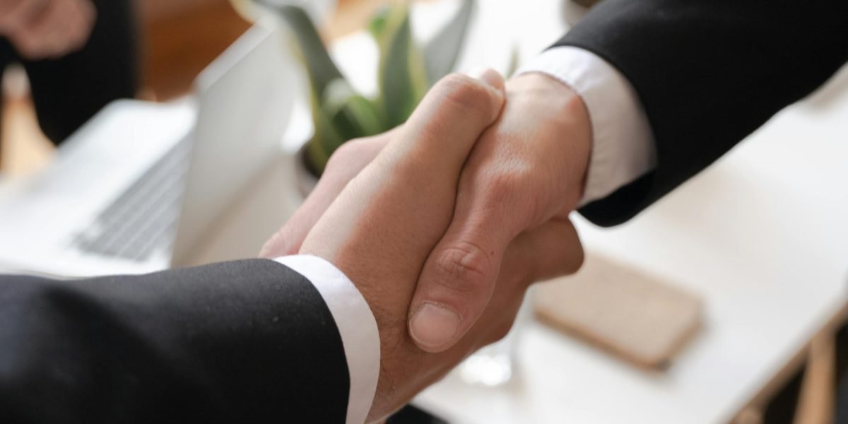 A handshake symbolizing trust and agreement between professionals, crucial when choosing real estate advisors.