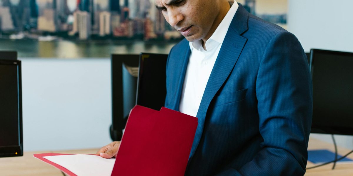 A diligent individual thoroughly reviewing documents, emphasizing the importance of personal due diligence in investments.
