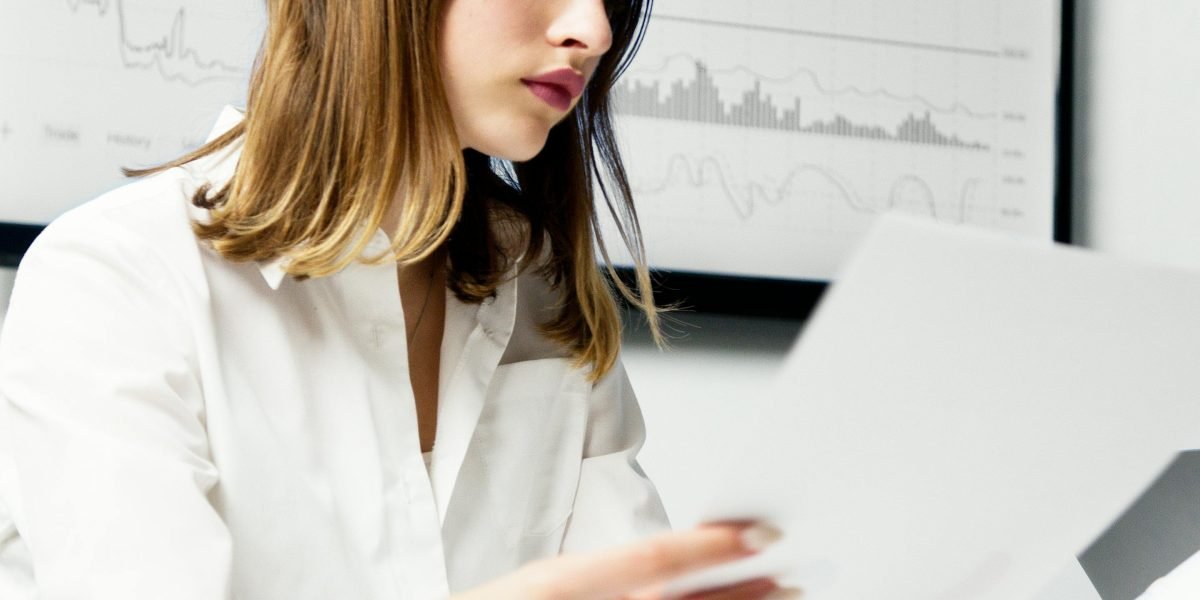 An investor carefully reviewing financial documents and charts to make informed decisions about REIT selections.