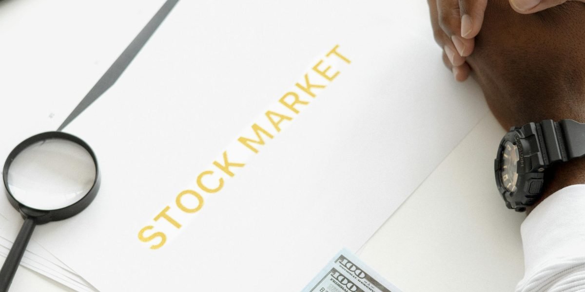 An individual using a map or digital tool to strategically plan and choose an investment location.