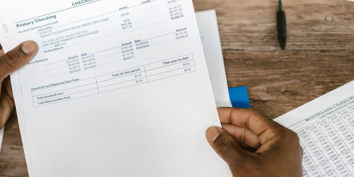 An individual diligently reviews financial documents to assess their investment readiness.