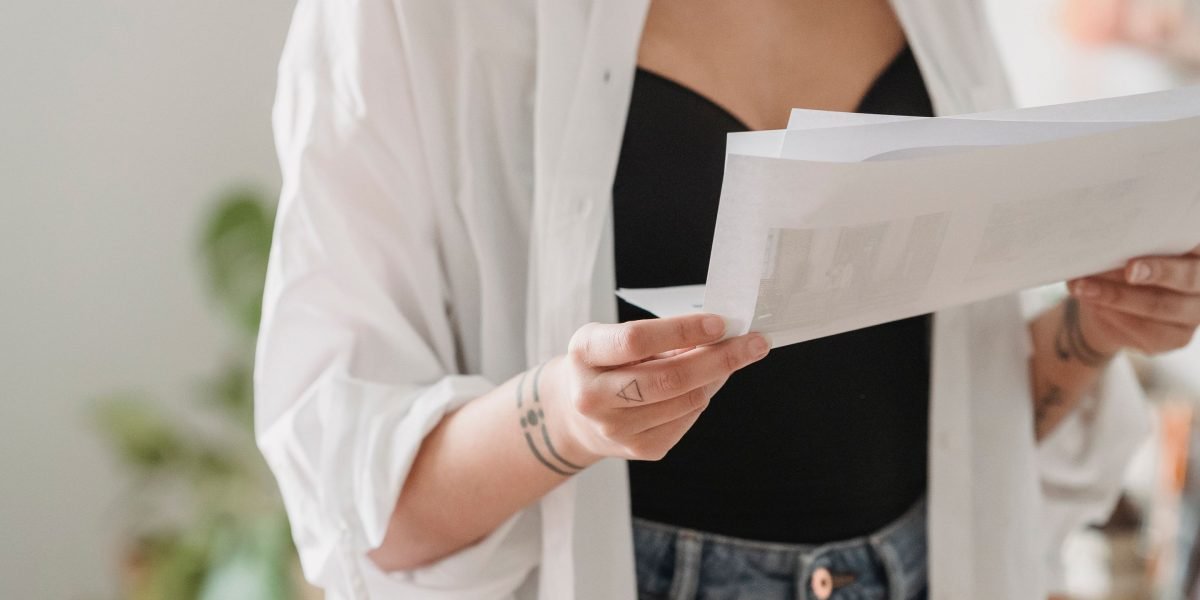 A person reviews legal documents, symbolizing the process of understanding and preparing for tax obligations.