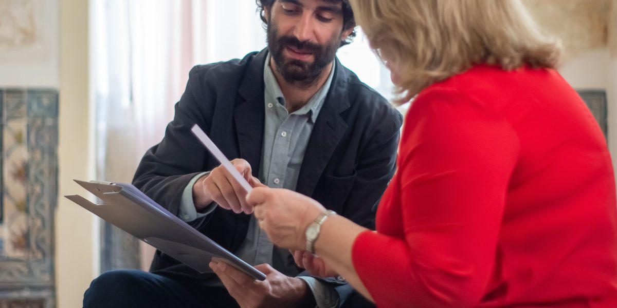A professional consultant discusses financial matters with a client, illustrating expert guidance for complex tax situations.