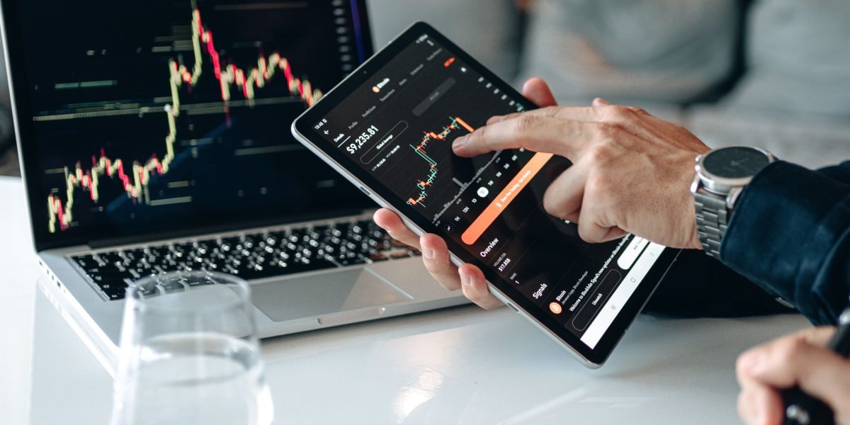 A person analyzing market data to identify key trends and signals for property investment decisions.