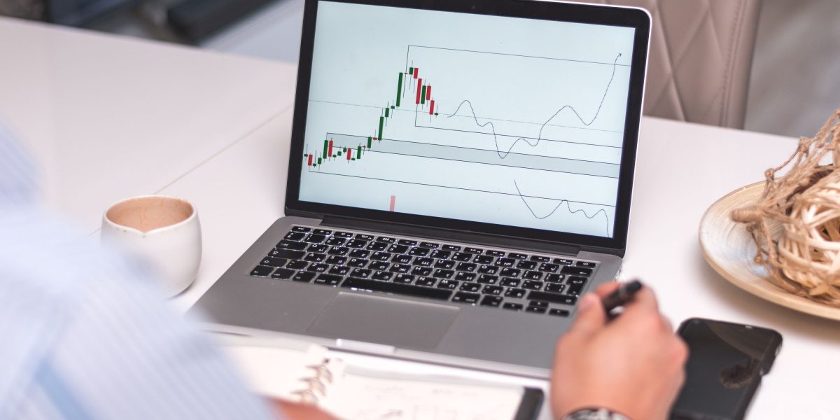 A person analyzing market trends or economic data, reflecting the need to understand real estate market cycles for informed decisions.
