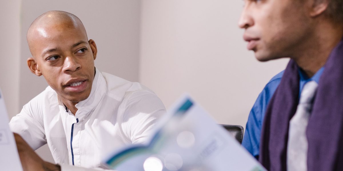 Professionals engaged in a serious discussion during a business meeting, emphasizing the role of expert consultation.