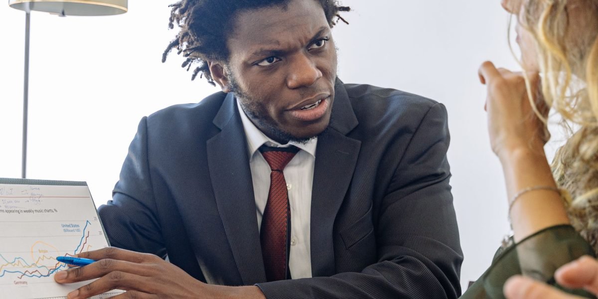 An experienced financial advisor explains investment options to a client, providing guidance for foreign investors.