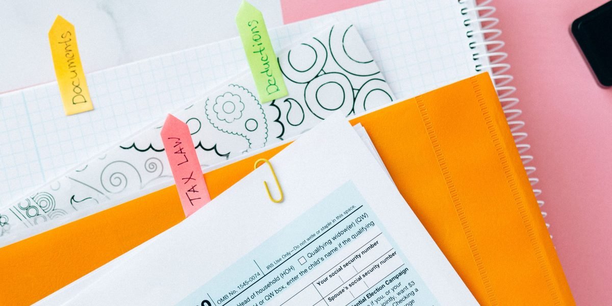 A person meticulously organizing financial documents and receipts for tax filing.