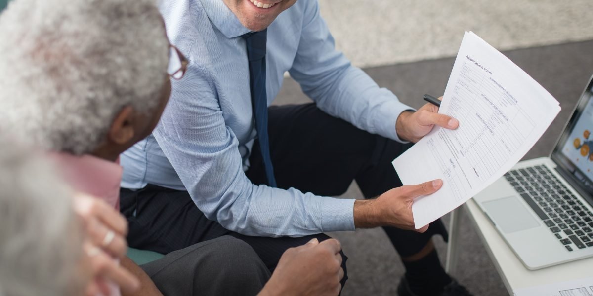 An expat couple receiving expert advice from a financial advisor, addressing unique investment questions in the UAE.