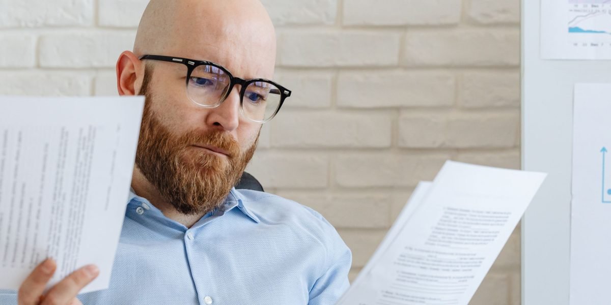 An investor carefully reviews documents, considering their tax obligations and strategies.