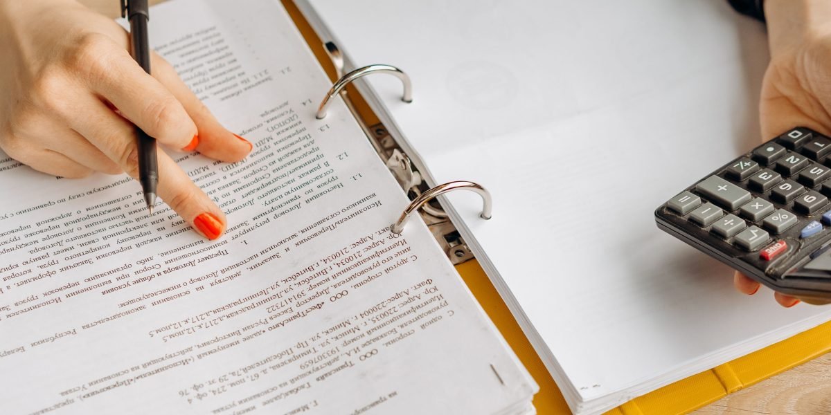 A professional thoughtfully analyzing complex tax documents related to property investments.