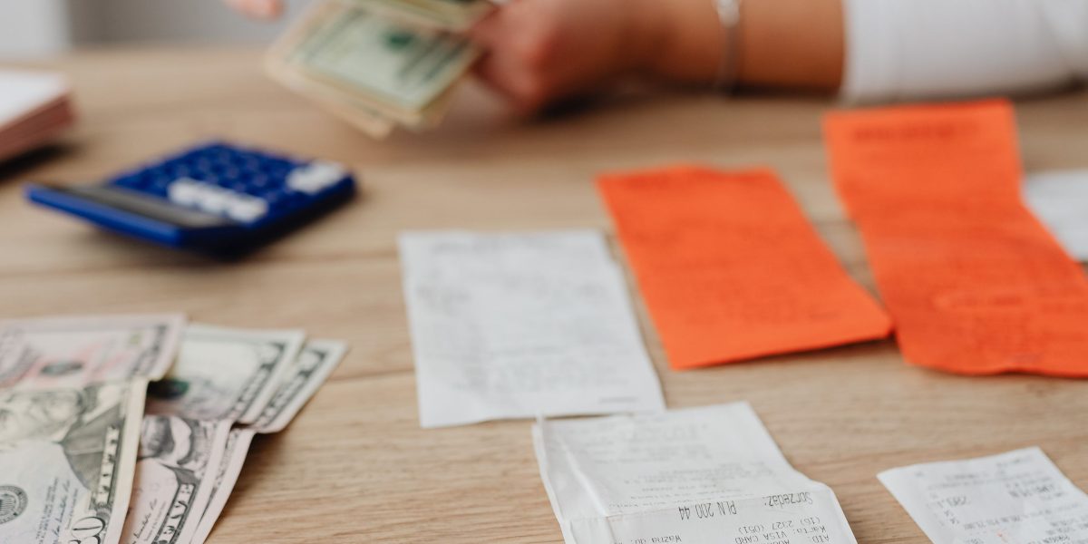 A diligent professional meticulously organizing receipts and records for business travel expenses.