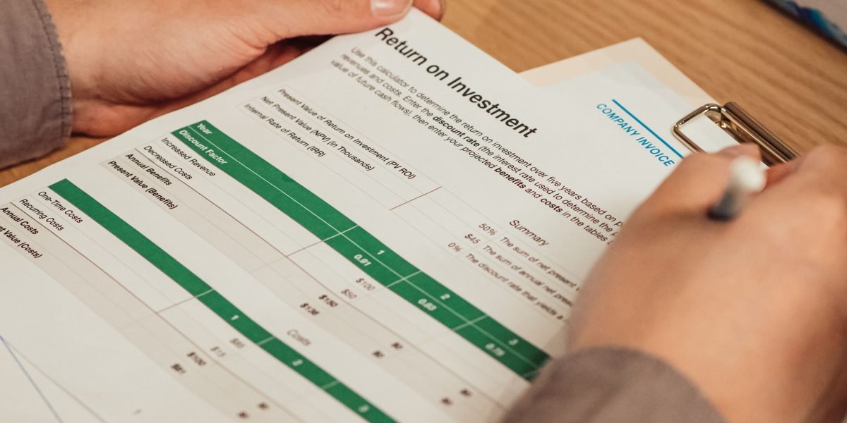 An expert reviewing financial statements and property asset lists to calculate depreciation.