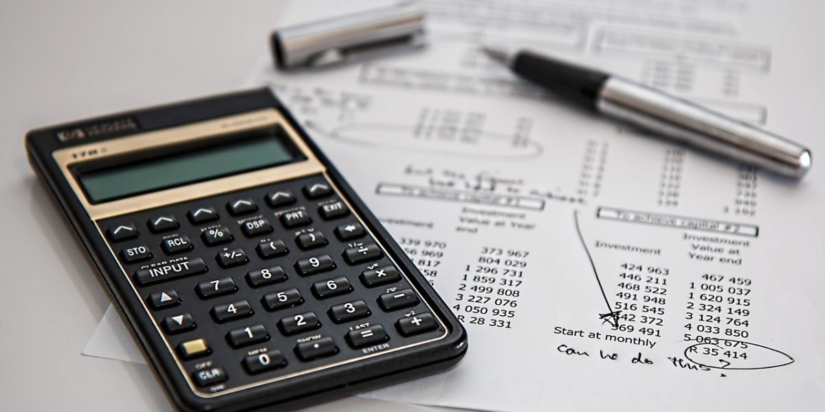 An individual carefully reviews financial documents, reflecting the importance of understanding tax thresholds.