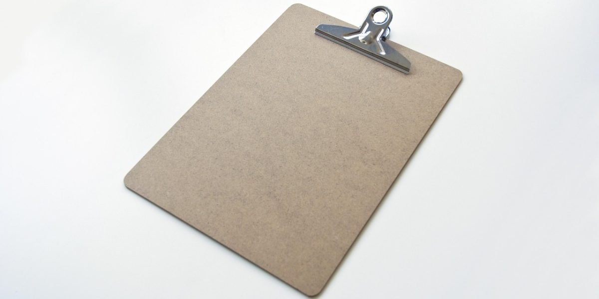 A professional meticulously examining papers, symbolizing the due diligence process.