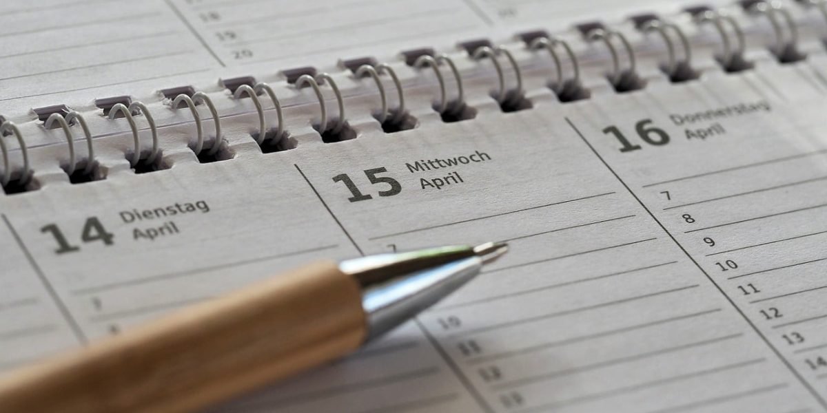 A person organizing their schedule, highlighting crucial deadlines for corporate tax filing and payments.