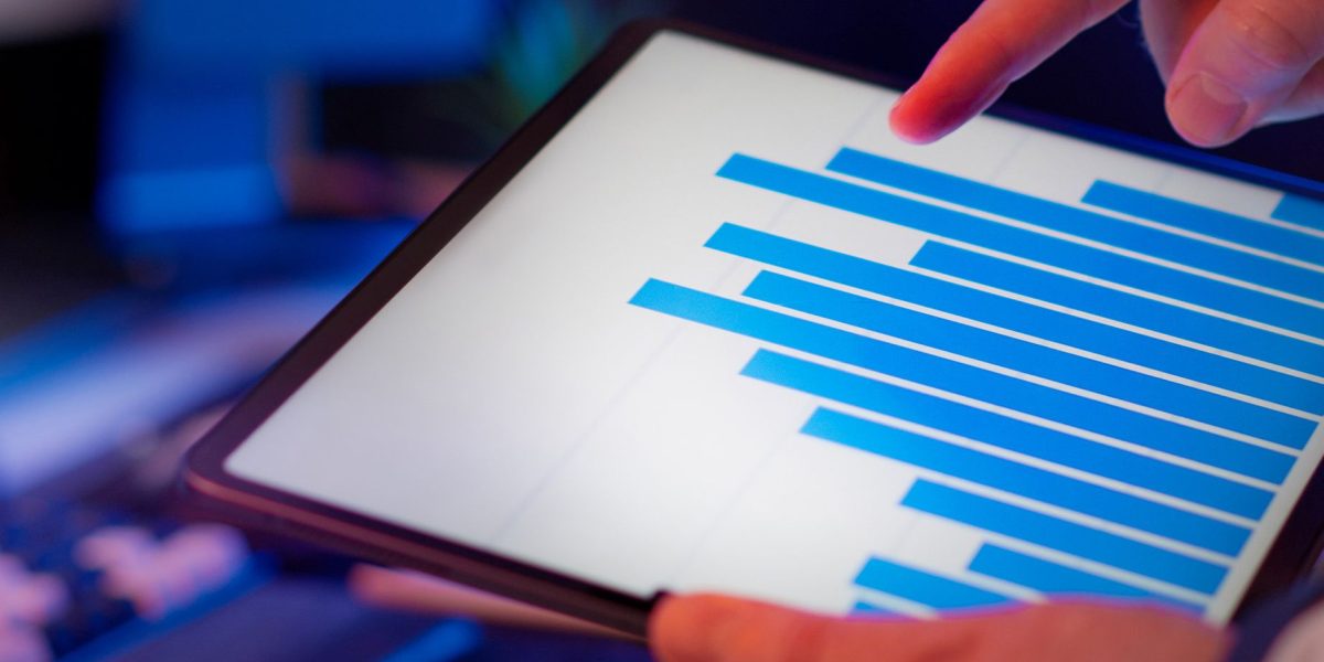 An investor meticulously reviews market data, using real estate indices to navigate complex property investment decisions.
