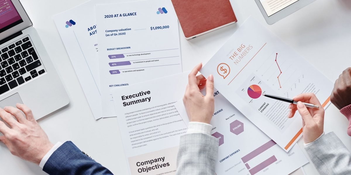 A diverse team collaborates, analyzing financial reports and data to understand market dynamics and construct accurate indices.