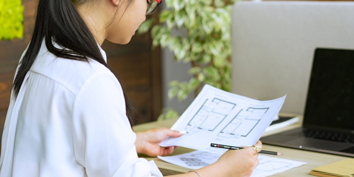 An individual deeply focused on reviewing business documents, symbolizing the process of understanding core tax fundamentals.