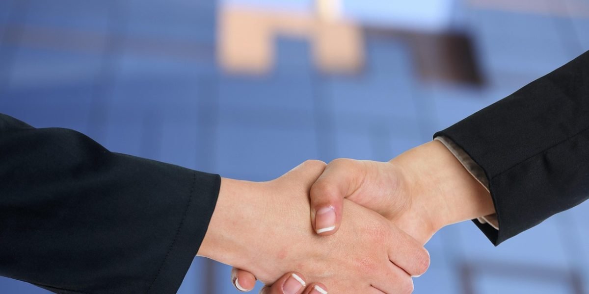 Professionals conclude a successful meeting, symbolizing a decision or partnership for CRM implementation.