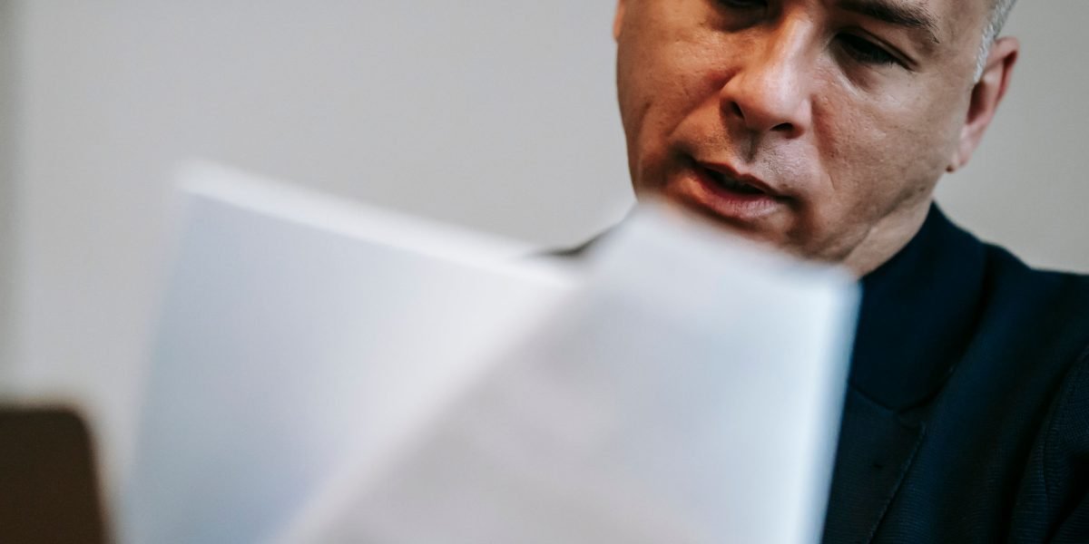 A confident investor in Dubai reviews financial documents, empowered by efficient tax and accounting software.
