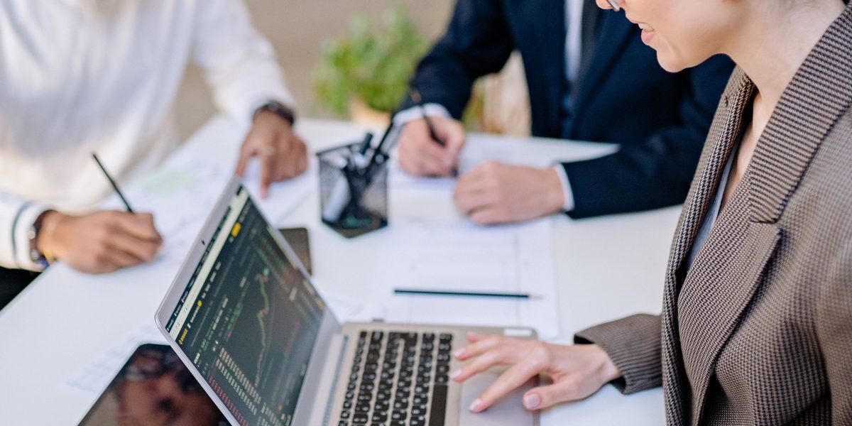 Business professionals engage in a strategic discussion about tax implications and financial planning.